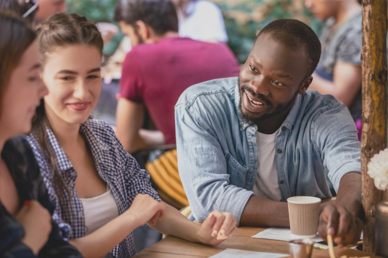 Finance professionals collaborating on investment analysis with multiple monitors showing market data